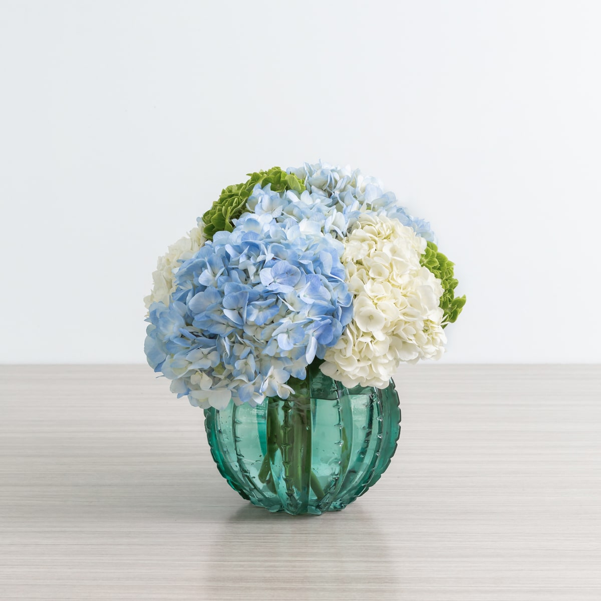 Peridot vase arrangement with assorted hydrangeas from Le Bouquet St.Laurent