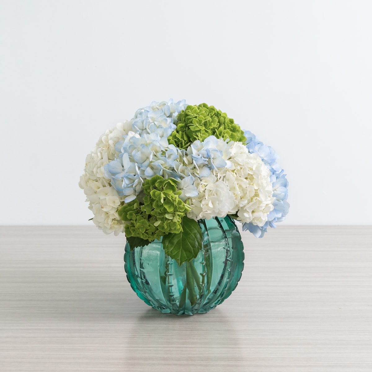 Peridot vase arrangement with assorted hydrangeas from Le Bouquet St.Laurent