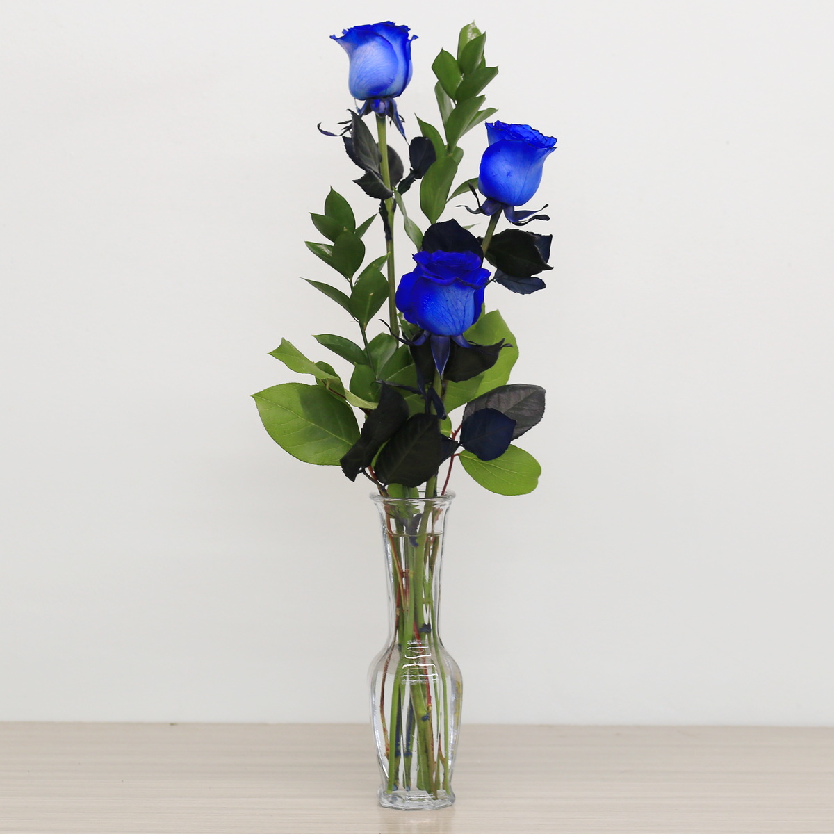 Blue roses with greenery arrangement