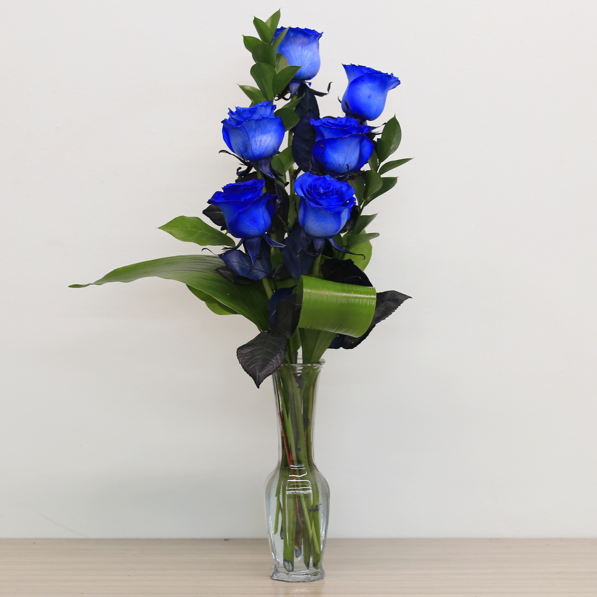 Blue roses with greenery arrangement