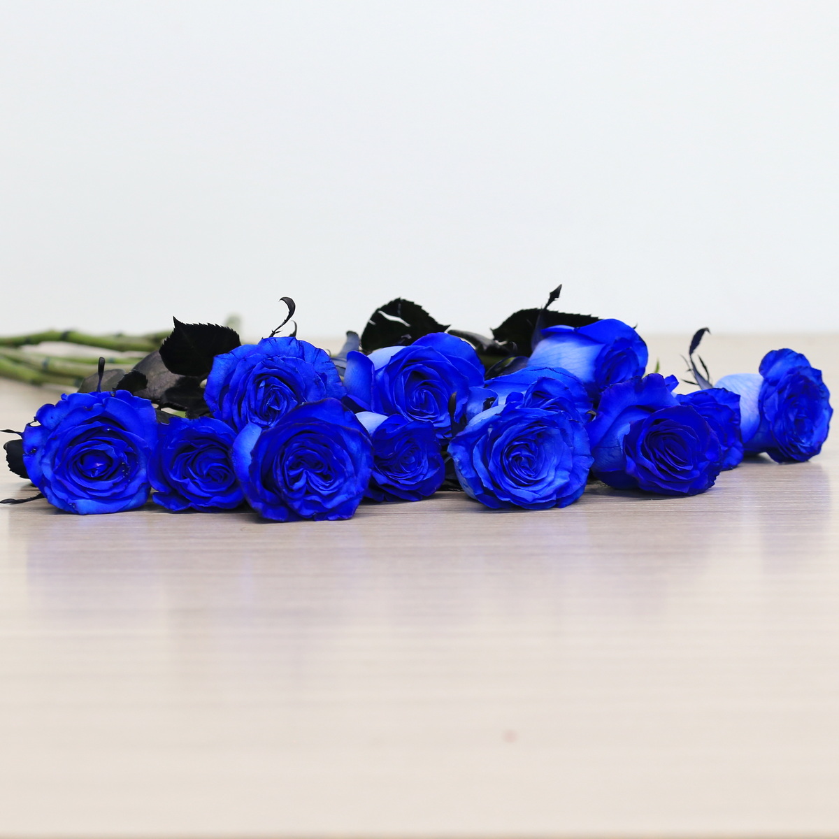 Blue roses with greenery arrangement