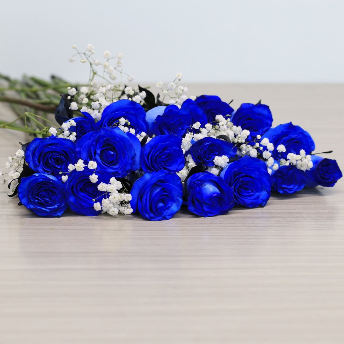Blue roses with greenery and floral accents