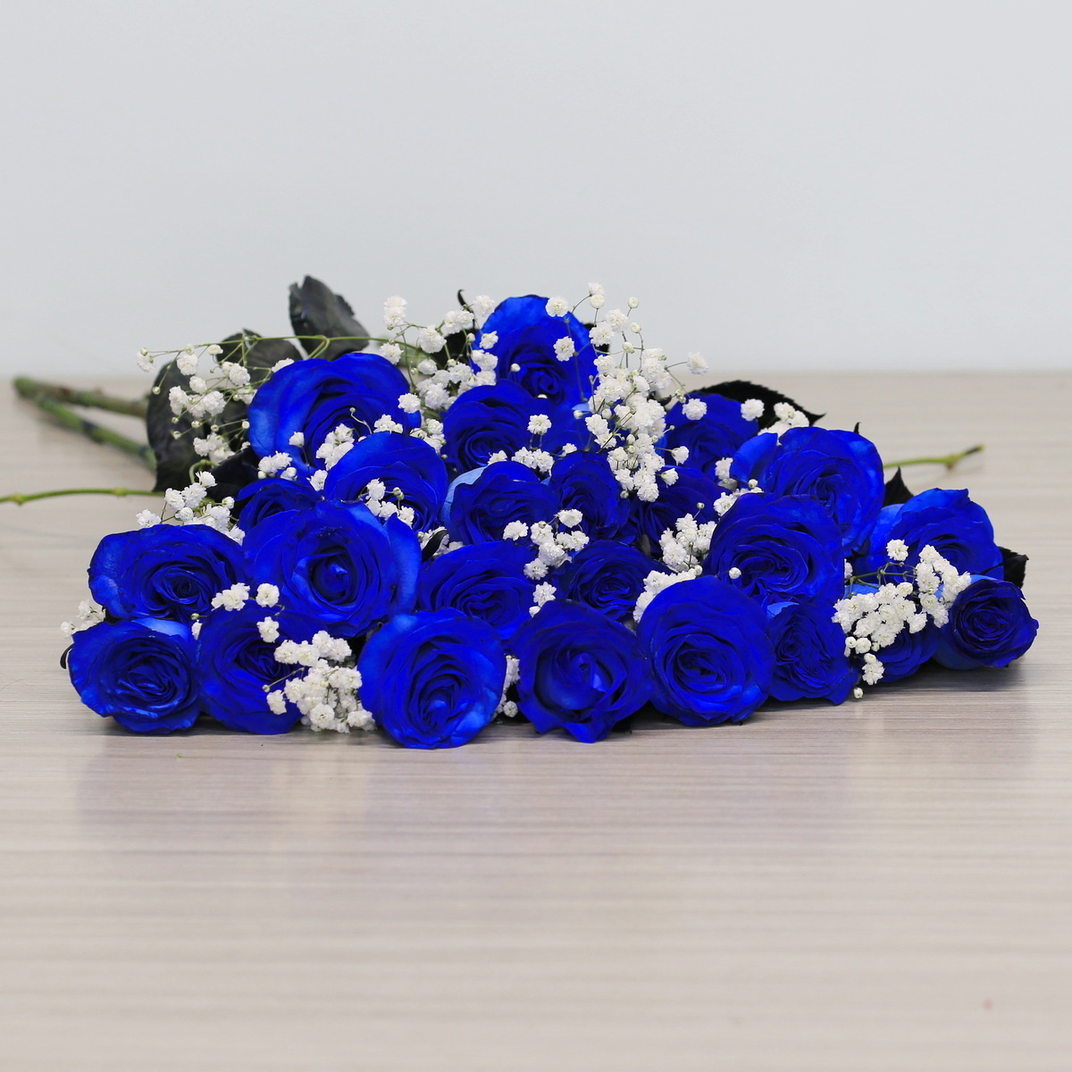 Blue roses with greenery and floral accents