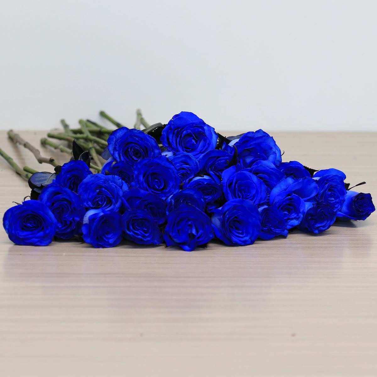 Blue roses with greenery arrangement