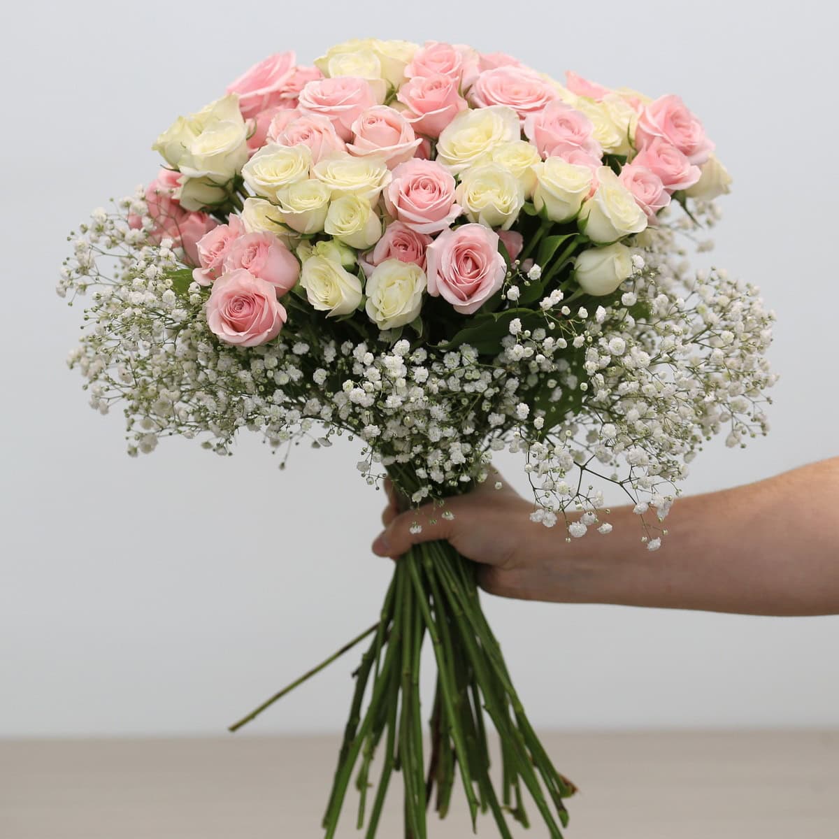 Aurora arrangement with pink and white spray roses and baby's breath